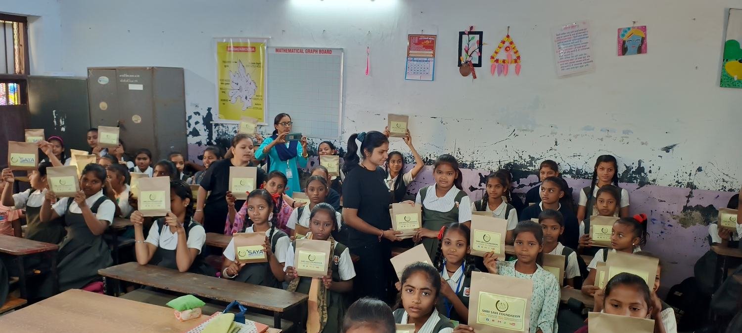 Schoolgirls holding dignity kits