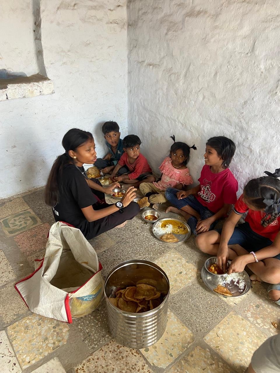 A volunteer serving food outside a shelter